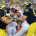 Michigan offensive linesman Joey Burzynski gets tangled up with Illinois defensive tackle Glenn Foster after the play is over during the first quarter at Michigan Stadium on Saturday.  Melanie Maxwell I AnnArbor.com